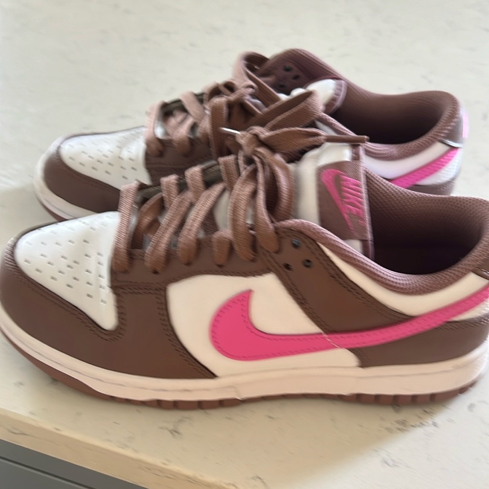 Nike dunks in brown white and pink.